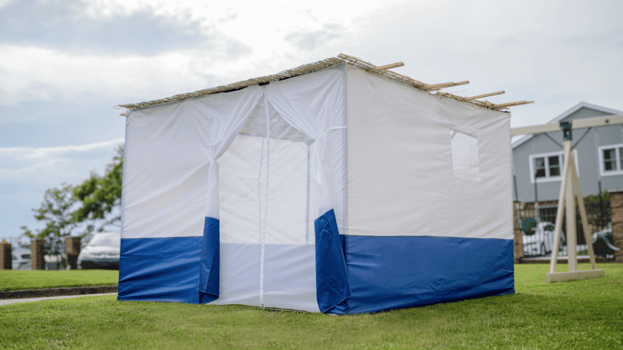 A traditional outdoor Sukkah featuring a high-quality Kosher bamboo schach roof covering, demonstrating proper installation and halachic compliance for the Sukkot holiday.