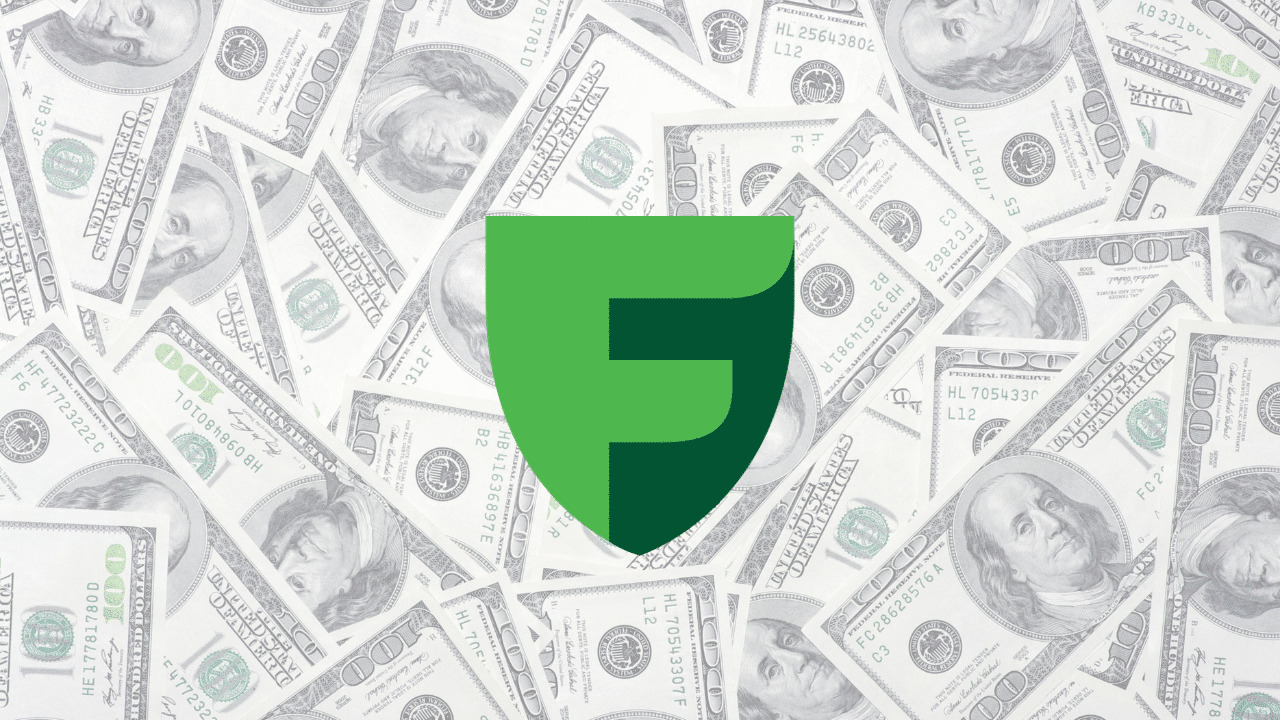 Freedom Holding Corp logo overlay on a background of US hundred-dollar bills, representing the financial success and billionaire status of CEO Timur Turlov.